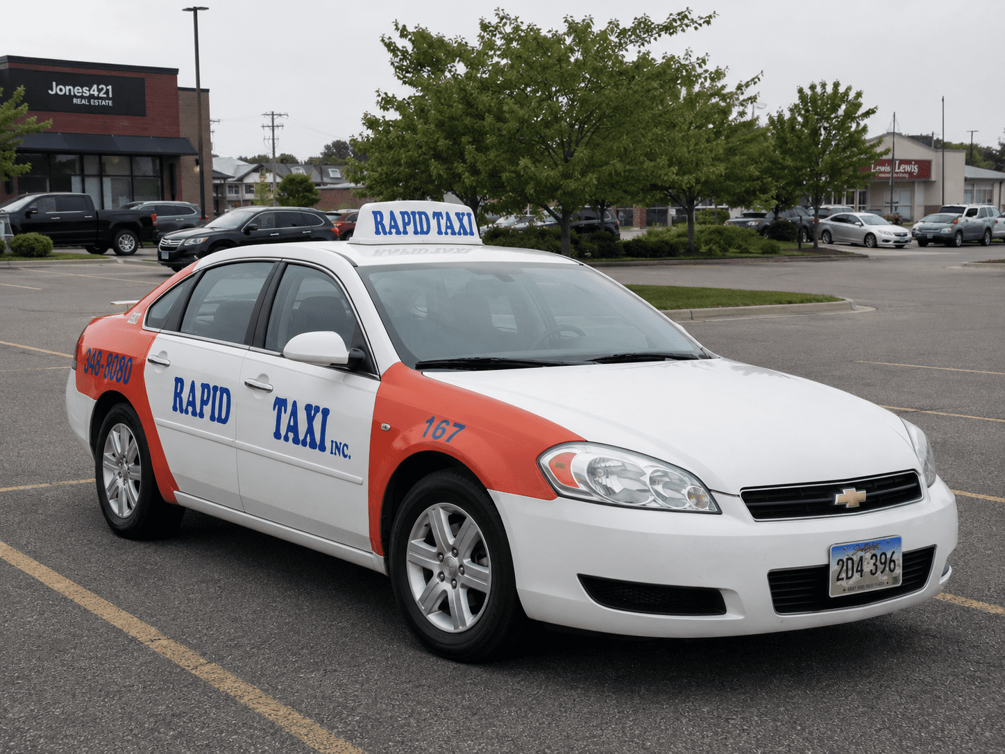 A white and orange Chevrolet Impala taxi cab with "RAPID TAXI INC." printed on the side door and a taxi light on the roof is parked in an asphalt parking lot